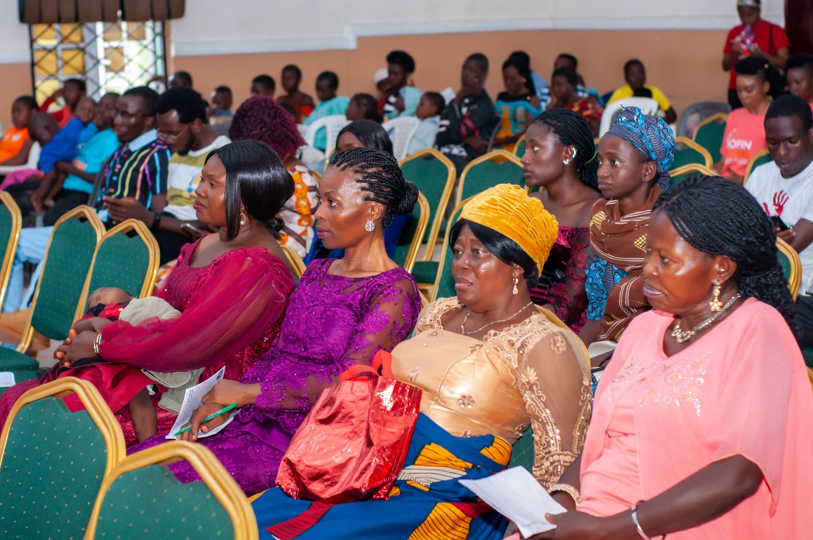 Women from the community seated together at the celebration